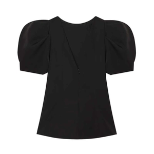 Detail view of the puff sleeves and back invisible zipper on this black minimalist top