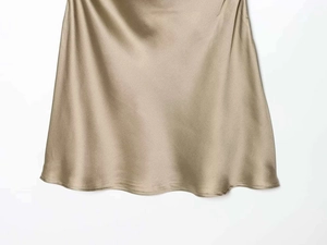 Detailed close-up showing the smooth texture and sheen of champagne gold satin fabric
