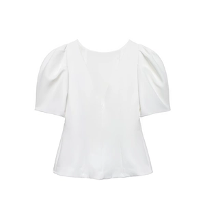 Detailed view of elegant white V-neck top with structured puff sleeves and smooth texture