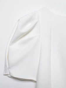 Close-up of white puff sleeves with pleated texture detail on trendy women top