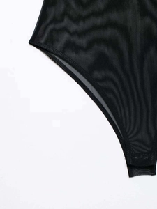 Close-up of black sheer mesh bodysuit showing fine seam edges and bottom snap fasteners