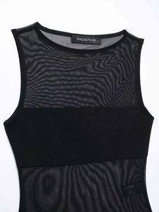 Detail of sheer mesh paneling and smooth black fabric on sleeveless bodysuit top
