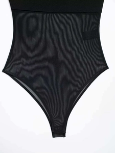 Close-up of black mesh bodysuit featuring intricate wave texture and transparent panels