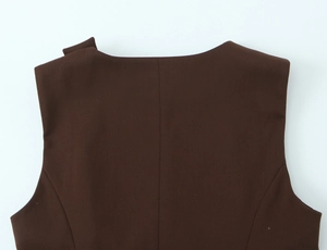 Detailed close-up of seamless stitching and woven fabric on the dark brown vest neckline