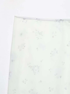 Detailed macro view of lightweight nylon fabric with delicate purple floral print patterns