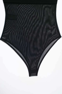 Detail of sheer mesh bodysuit with wide elastic waistband and breathable fabric texture
