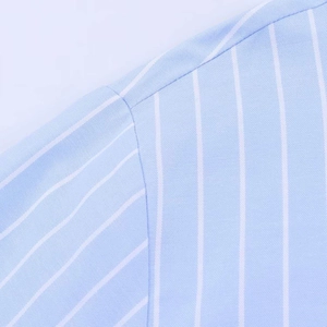 Close-up of fine white vertical stripes on light blue fabric with neat shoulder stitching