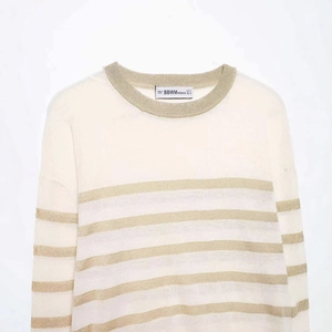 Chic cream knit sweater with metallic gold stripes and shimmering ribbed crew neck design