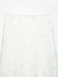 Detail of white floral nylon midi skirt featuring light grey flower patterns and sheer fabric