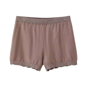 Detail shot of dusty pink knit shorts with a ruffled scalloped hem and elastic ribbed waistband