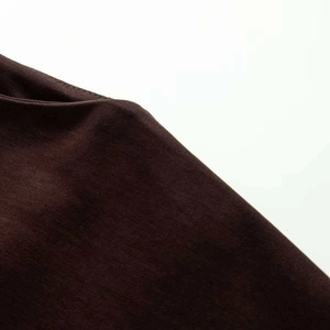 Detailed close-up showing the smooth stitching and fine texture of dark brown knit fabric