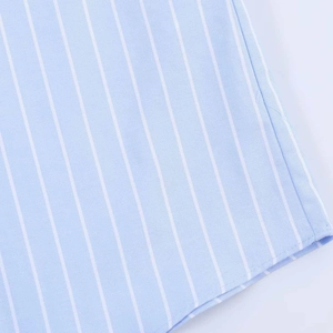 Close-up of light blue vertical striped fabric showing high-quality hem stitching