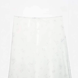 Minimalist white floral nylon midi skirt with delicate mesh overlay for a summery look