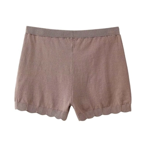 Detail showing scalloped hem and elastic waistband on mauve knitted lounge shorts