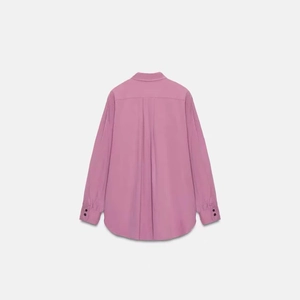 Minimalist long sleeve pinkish purple shirt featuring back pleats and curved hem details