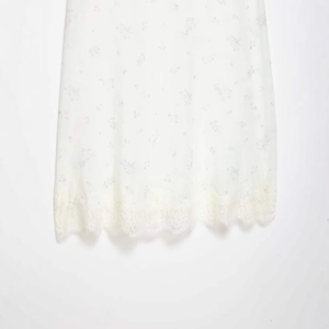 Minimalist white nylon skirt with delicate floral print and elegant eyelash lace trim detail