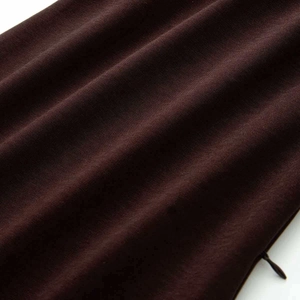 Close-up of the dark brown fabric texture and high-quality invisible zipper on the dress