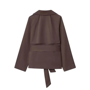 Detail view of the deep brown short trench coat back with storm flap and waist belt