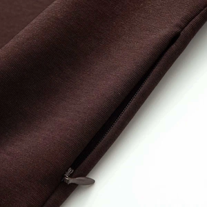 Close-up of dark brown fabric texture and high-quality invisible zipper on a summer dress