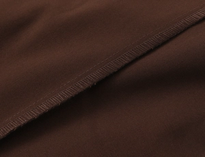Detailed close-up showing sewing craftsmanship and dark brown fabric texture