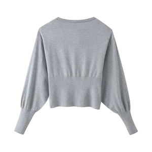 Back view of gray knit cardigan with puff sleeves and ribbed hem on white background