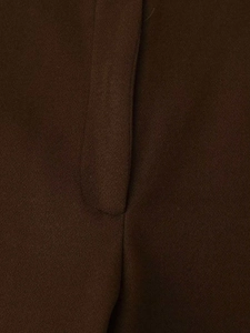 Detailed macro view of dark brown wool blend fabric with professional straight stitching
