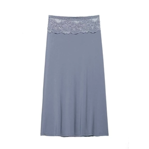 Detail of the high-waisted gray-blue skirt with intricate lace trim on the waistband