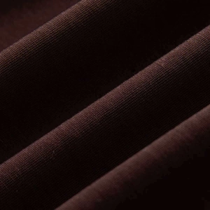 Macro detail of high-quality dark brown knitted fabric showing fine texture and elasticity