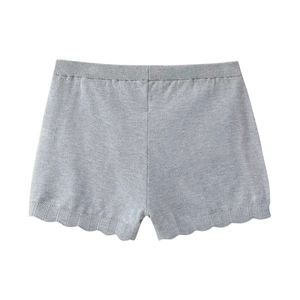Detail of grey knitted shorts with a scalloped hem and elastic high-waist band