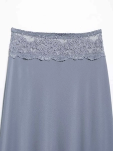 Detail of grey-blue satin skirt featuring elegant wide floral lace trim at the waist