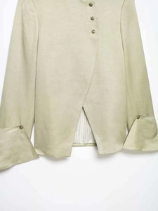 Detail of cross-collar shirt with vintage buttons, flared sleeves and striped lining