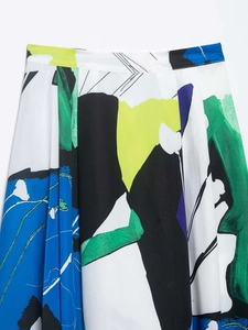 Detailed view of colorful abstract print on a high-waisted pleated midi skirt fabric