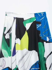 Detail of the high waist midi skirt featuring abstract artistic colorful print patterns