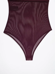 Detail showing sheer mesh texture and stitching on dark red sleeveless bodysuit