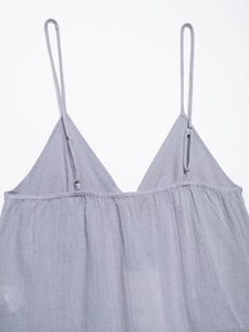 Detail of adjustable spaghetti straps and V-neckline on a grey embroidered camisole top