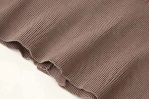 Macro shot of dark brown ribbed knit fabric texture showing vertical patterns and soft material