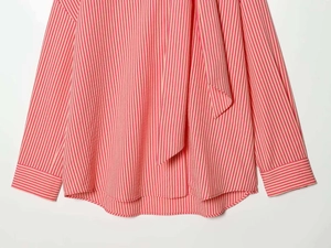 Detailed view of women's pink striped poplin shirt featuring a stylish tie-neck collar design