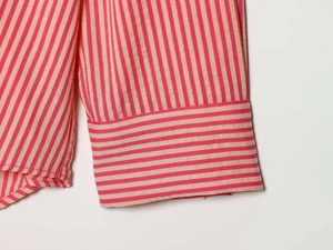 Detail of red and white striped cotton shirt cuffs with horizontal stripe patterns