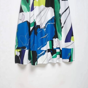 Artistic abstract print midi skirt with elegant pleated hem and vibrant color block design