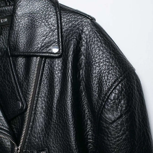 Classic black motorcycle jacket in lychee grain leather with silver metal zipper detail