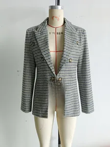 Detail of classic plaid double-breasted blazer with large lapels and textured buttons