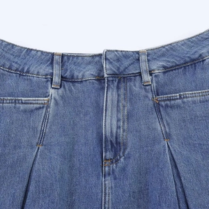 Vintage high waist pleated denim skirt with raw hem in classic washed blue denim