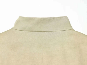 Detail shot of khaki blazer lapel with high-density stitching and fine fabric texture