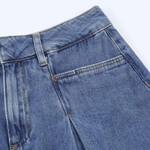 Detail of high-waisted denim skirt featuring yellow contrast stitching and belt loops