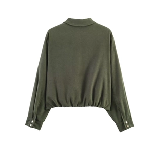 Detail of the elastic hem and dark green suede texture on this cropped fashion jacket