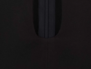 Close-up of a seamless back zipper closure on a black puff sleeve dress textile