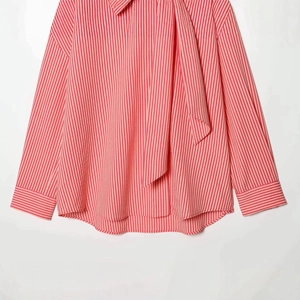 Women's pink striped long sleeve poplin shirt with a tie-neck design and loose fit