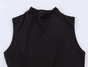 Detail of black slim-fit sleeveless dress with high neck and back button closure