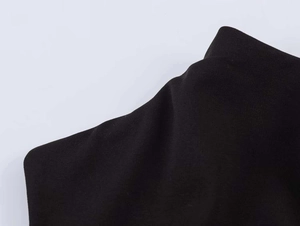 Macro shot of breathable black knit cotton fabric texture showing detailed stitch patterns