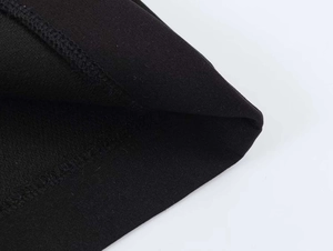 Detailed macro view of black elastic knit fabric texture and high-quality edge overlock stitching